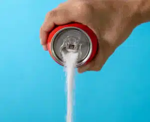 Illustration showing the effects of soda on teeth by demonstrating its sugar content