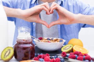 heart-shaped hands with breakfast and healthy food 