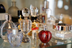 Assorted perfume bottles symbolizing toxic perfumes and health risks from synthetic fragrance chemicals.